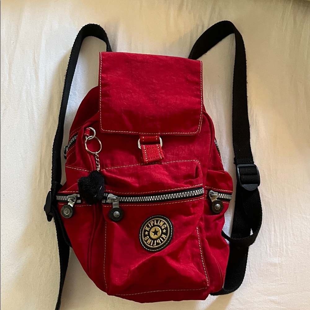 Kipling Red Backpack with Adjustable Straps and Metallic Hardware